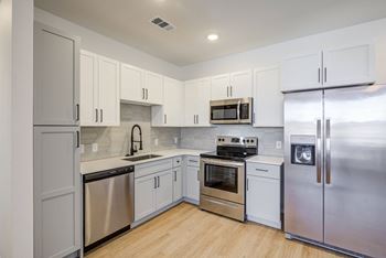 Designer cabinetry, stone counters and custom tile backsplash